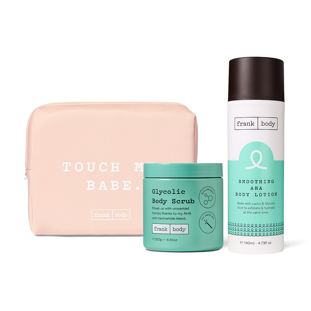 The frank body Acid Heroes Kit: Glycolic Body Scrub and Smoothing AHA Body Lotion with a pink Touch Me Babe pouch.