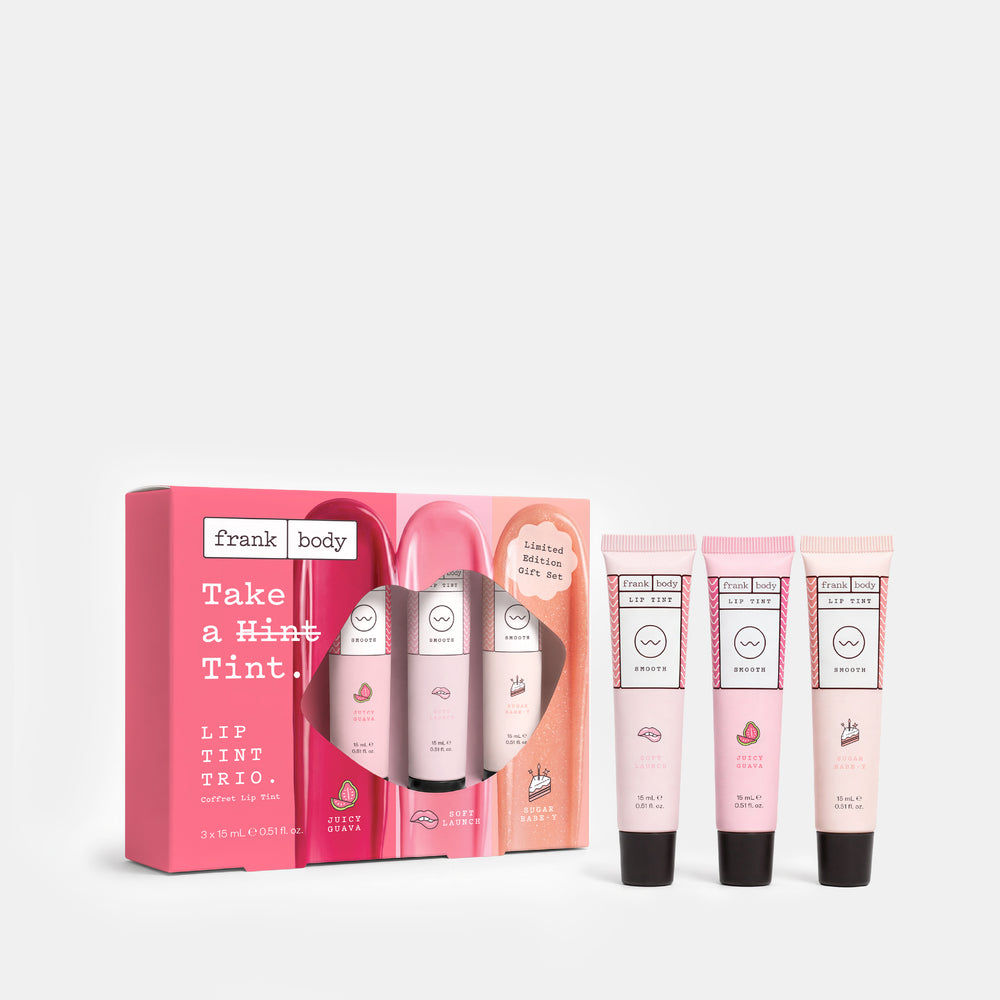 Frank Body Lip Tint Trio gift set featuring a pink box with three lip tint tubes displayed in front on a light gray background.