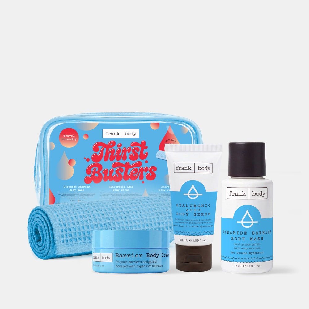 The frank body Thirst Busters Kit with the barrier body cream, hyaluronic body serum and ceramide body wash beside a blue bag and waffle towel on white.