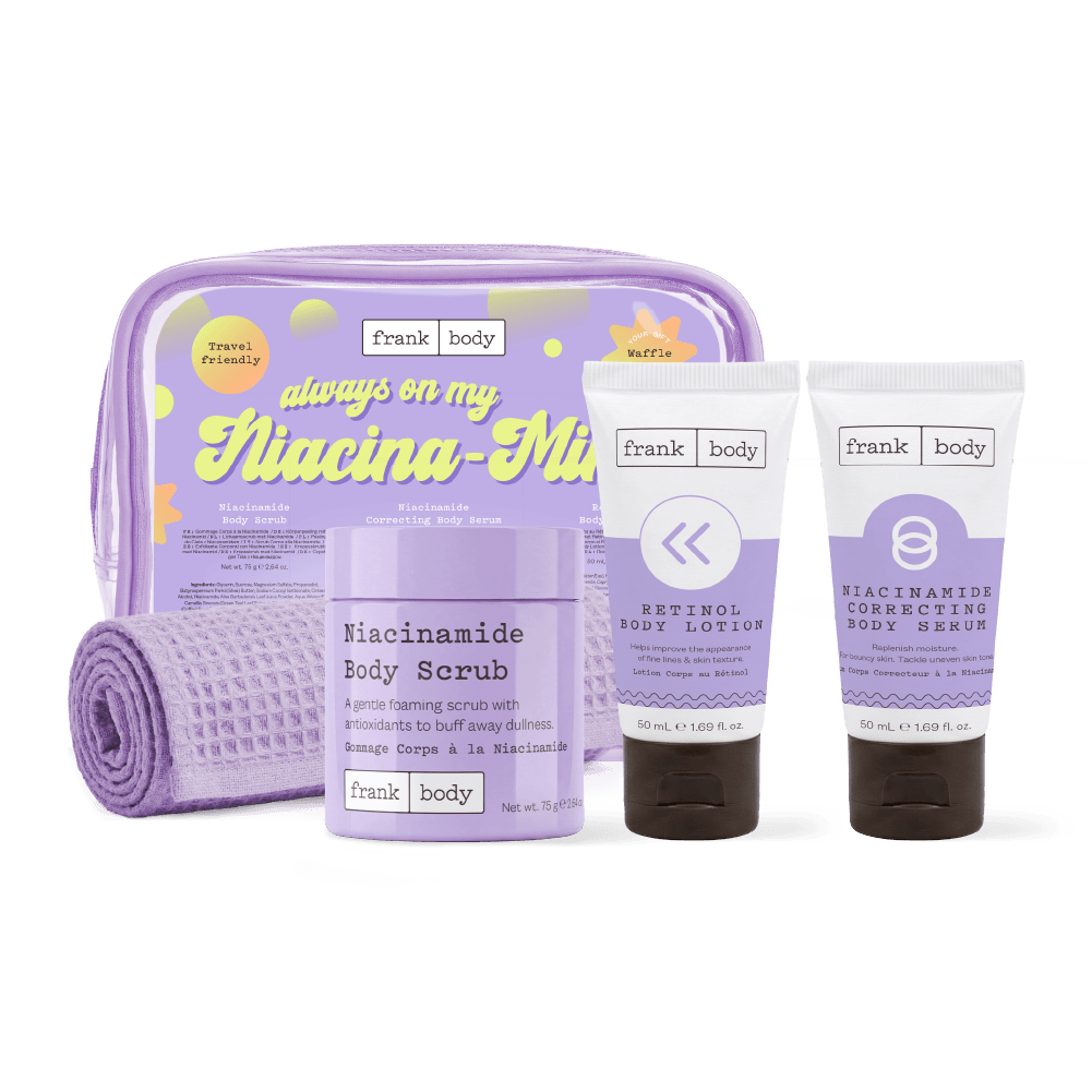 The frank body Always On My Niacina-mind Kit: a lilac travel bag and waffle towel with the Niacinamide Body Scrub, Retinol Body Lotion and Niacinamide Correcting Body Serum.