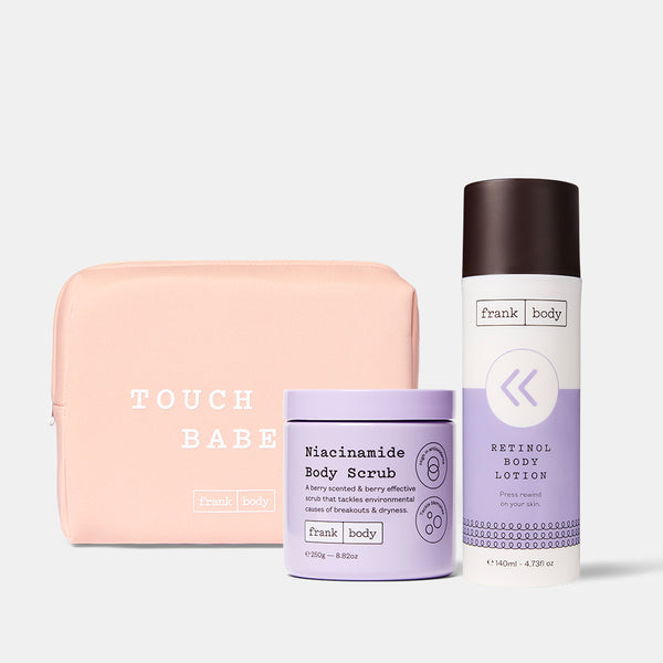 The frank body Niacinamide Era Kit: Niacinamide Body Scrub and Niacinamide Correcting Body Serum with a pink Touch Me Babe pouch.